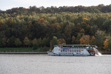 Wheeled pleasure motor ship on the Moscow river against the background of Vorobyevskaya embankment, autumn 2020, Moscowの写真素材