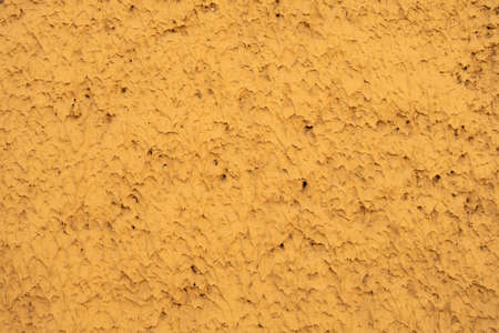 Concrete wall covered with thin sharp strokes of plaster, background
