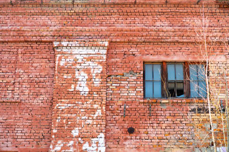 Window in an old brick wall, red brick laying, background