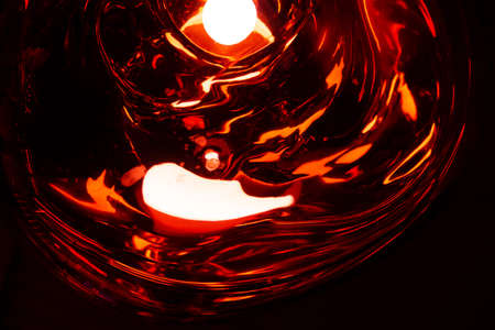 Glare from illumination of thick molded glass, abstract background, mood