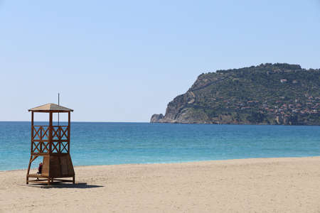 Lifeguard booth on a deserted beach against the backdrop of a calm sea and cliffs, minimalism, Alanya, Turkey, 2021の写真素材