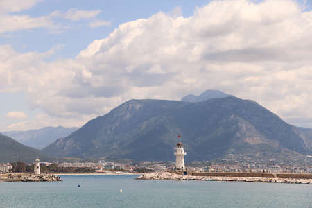 Lighthouse in the port of Alanya against the backdrop of the city at the foot of the mountain, Turkey, April, 2021の写真素材