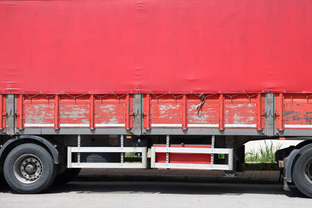 Turkey, Alanya, April 18, 2021. Red tarpaulin on the trailer, shabby side, minimalism, bright...