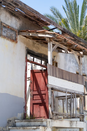 Wooden porch of an old abandoned house against a background of palm trees, door, sign, Alanya, 2021のeditorial素材
