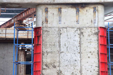 Concrete support of the flyover with the remains of steel formwork, construction background, Moscow,...