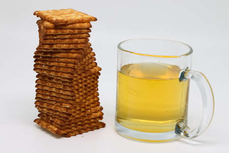 Glass mug of green tea and stack of cookies, diet and nutrition, backgroundの写真素材