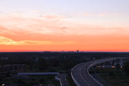 Flaming sunset against the background of the bridge over the Volga, bright background, Dubna, Moscow region, July, 2021の写真素材