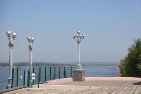 Street lights on the Samara pier against the backdrop of the Volga and the city beach, August, 2021の写真素材