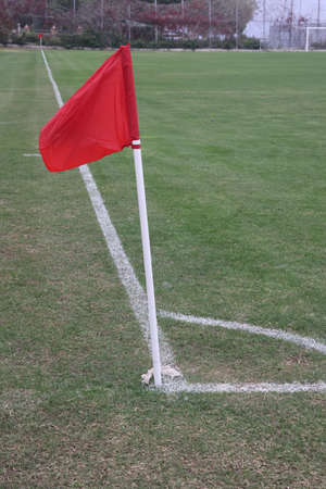 Corner flag on soccer field flutters in the wind, red flag, soccer game.の写真素材
