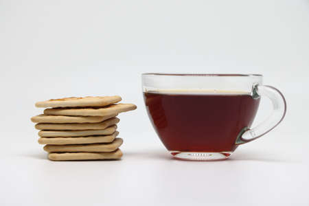 Glass cup of tea and a stack of biscuits, proper nutrition.