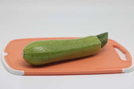 Unpeeled green zucchini, zucchini on a cutting kitchen board.の写真素材