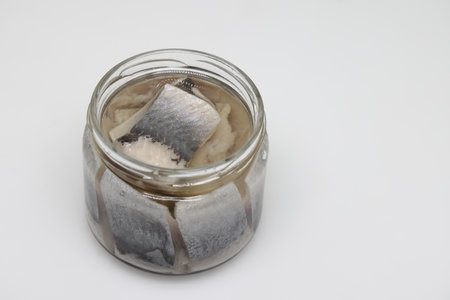 Puddle of condensed milk flows from levitating jar, can opener, black bread.
