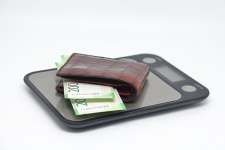 Electronic kitchen scales with banknotes, accounting and control of family expenses.