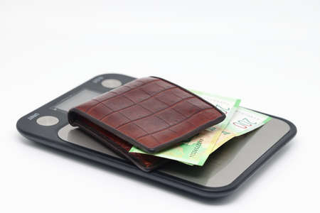 Electronic kitchen scales with banknotes, accounting and control of family expenses.