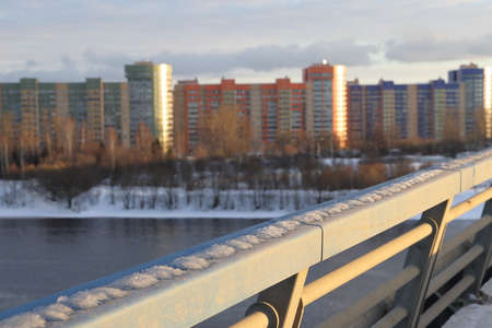 Bridge across the Volga, unfrozen river, winter landscape, snow and bushes along the banks of the river, Russiaの写真素材