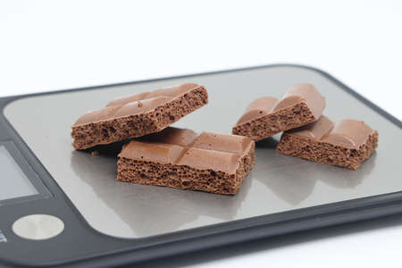 porous pieces of chocolate on a white background. Health food. The concept of a healthy lifestyle....