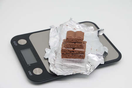 porous pieces of chocolate on a white background. Health food. The concept of a healthy lifestyle. weight control.の写真素材