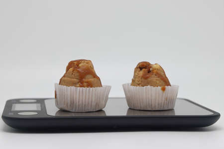 Cakes on electronic kitchen scales. unhealthy foods. The concept of a healthy lifestyle. diet...