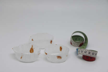 paper sockets for cakes. Cakes on electronic kitchen scales. unhealthy foods. The concept of a...