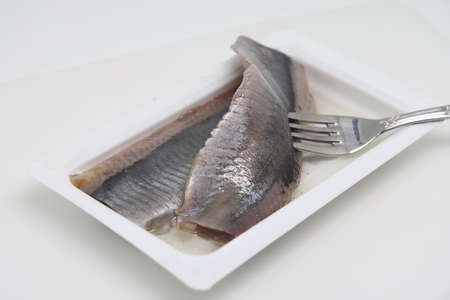 Salted herring on a white background. Health food. The concept of a healthy lifestyle. weight controlの写真素材