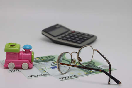 Banknotes, calculator, train toy, planning of future trips, quarantine will endの写真素材