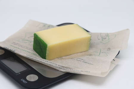 Pieces of cheese on the scales. Weight loss, diet and weight control. Still life with healthy food and scales. Health food. The concept of a healthy lifestyle. weight controlの写真素材