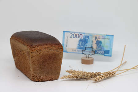 Close up of traditional bread. A loaf of bread on the background of a banknote. world food crisis....
