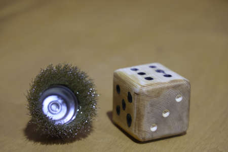 wooden dice and metal brush head, handmade dice. unpredictability