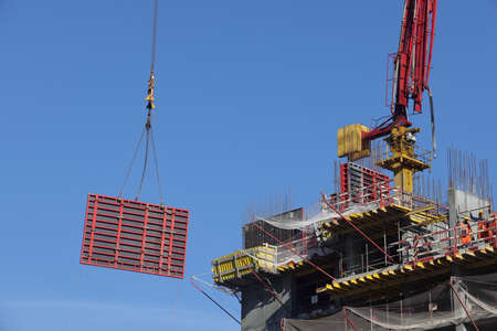 Construction site with cranes against the sky. Construction machinery, construction of skyscrapers