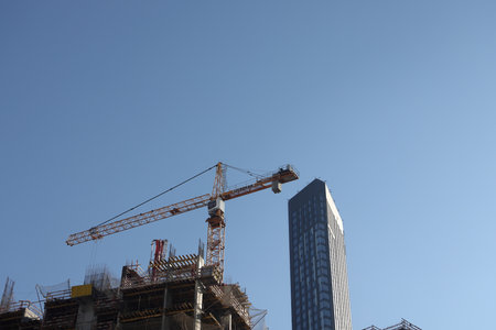 Construction site with cranes against the sky. Construction machinery, construction of skyscrapers