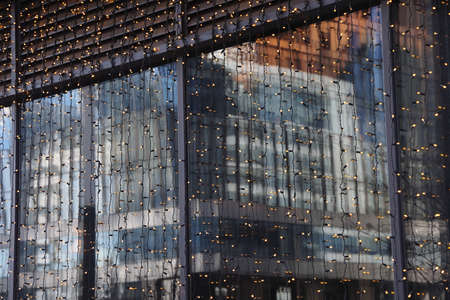 Futuristic design part of skyscrapers against a clear blue sky. Abstract facade design. Glass and...