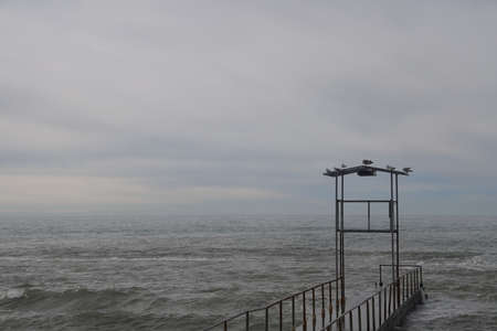 Sochi, Russia 05.07.2021. Breakwater pier summer black sea cloudy