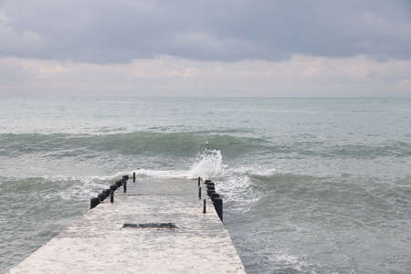 Sochi, Russia 05.07.2021. Breakwater pier summer black sea cloudyの写真素材