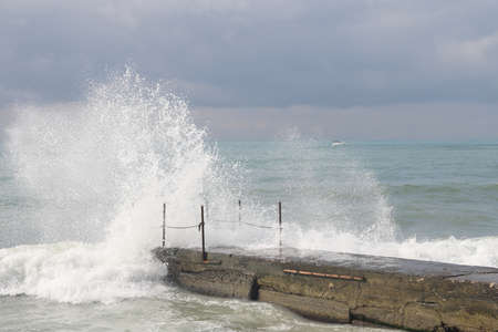 Sochi, Russia 05.07.2021. Breakwater pier summer black sea cloudy