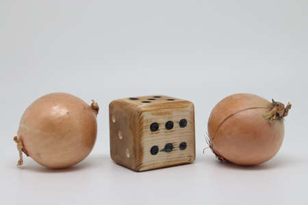 Two onions and a homemade dice isolated on a white background, proper nutritionの写真素材