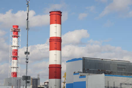 Silhouette High voltage electric tower on the background of the power plant