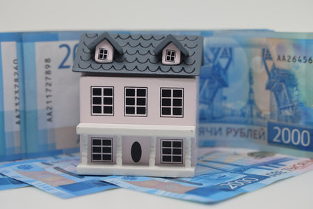 toy house on banknotes, buying your own home, mortgage, symbol of material well beingの写真素材