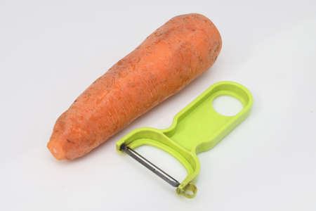 Poorly washed carrots and peelers, carrots spoil, proper nutritionの写真素材