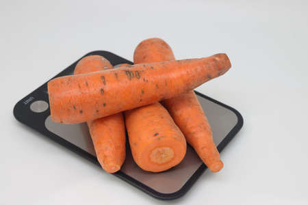 Poorly washed carrots lie on the kitchen electronic scales, carrots decay, calorie counting, proper nutritionの写真素材