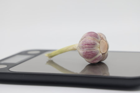 head of garlic on electronic kitchen scales, proper nutrition, take into account caloriesの写真素材