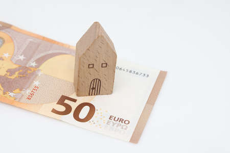 Buying and building a house. House and money. real estate market. house with gray roof on euro...