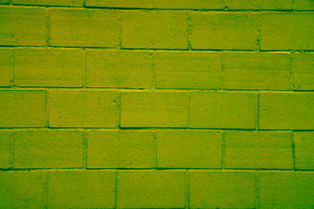 Heavily edited photo of a brick wall with bricks stacked in rows. The plaster between the bricks has green and red hues. Changed color schemeの写真素材