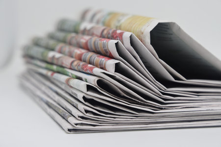 Rolled up stack of newspapers, news, corrupt journalismの写真素材