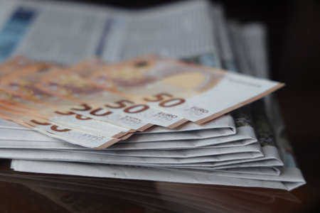 Rolled up stack of newspapers, news, corrupt journalismの写真素材