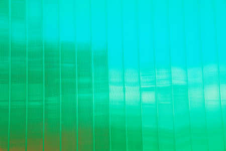 background of glass windows of a modern office building, glass facade, changed color schemeの写真素材