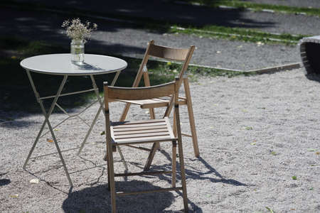 An empty table in a cafe, on it is a bouquet in a transparent jar, Moscow, June 2022の写真素材