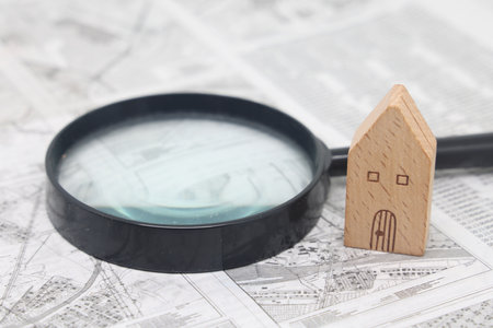 Wooden model house stands on the scheme of land plots, real estate purchaseの写真素材