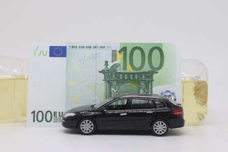 A bottle of vegetable oil and a typewriter lie on a banknote. Biodiesel, biofuel, vegetable oil, fuel crisis, rising fuel prices, biofuel shortageの写真素材