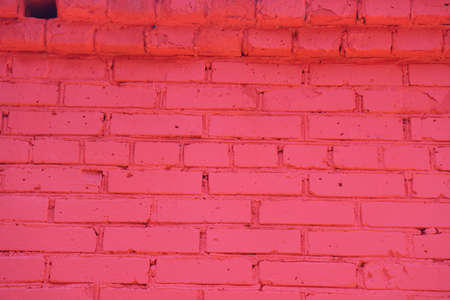 Old red brick wall painted with fresh paint. Brickwork with uneven seams texture of the design...