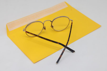 The glasses are in an open envelope. Corporate desktop, receiving correspondence. The concept of...
